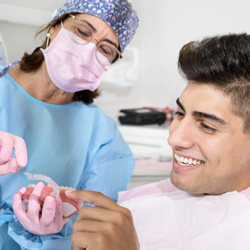 Invisalign patient in Minot smiling at dentist