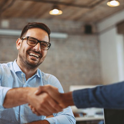 Patient in Minot smiling with Invisalign at work