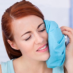 Woman icing her cheek