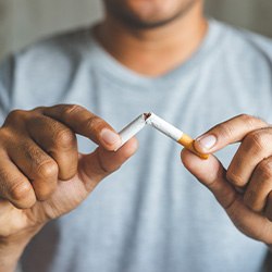 Closeup of patient breaking cigarette